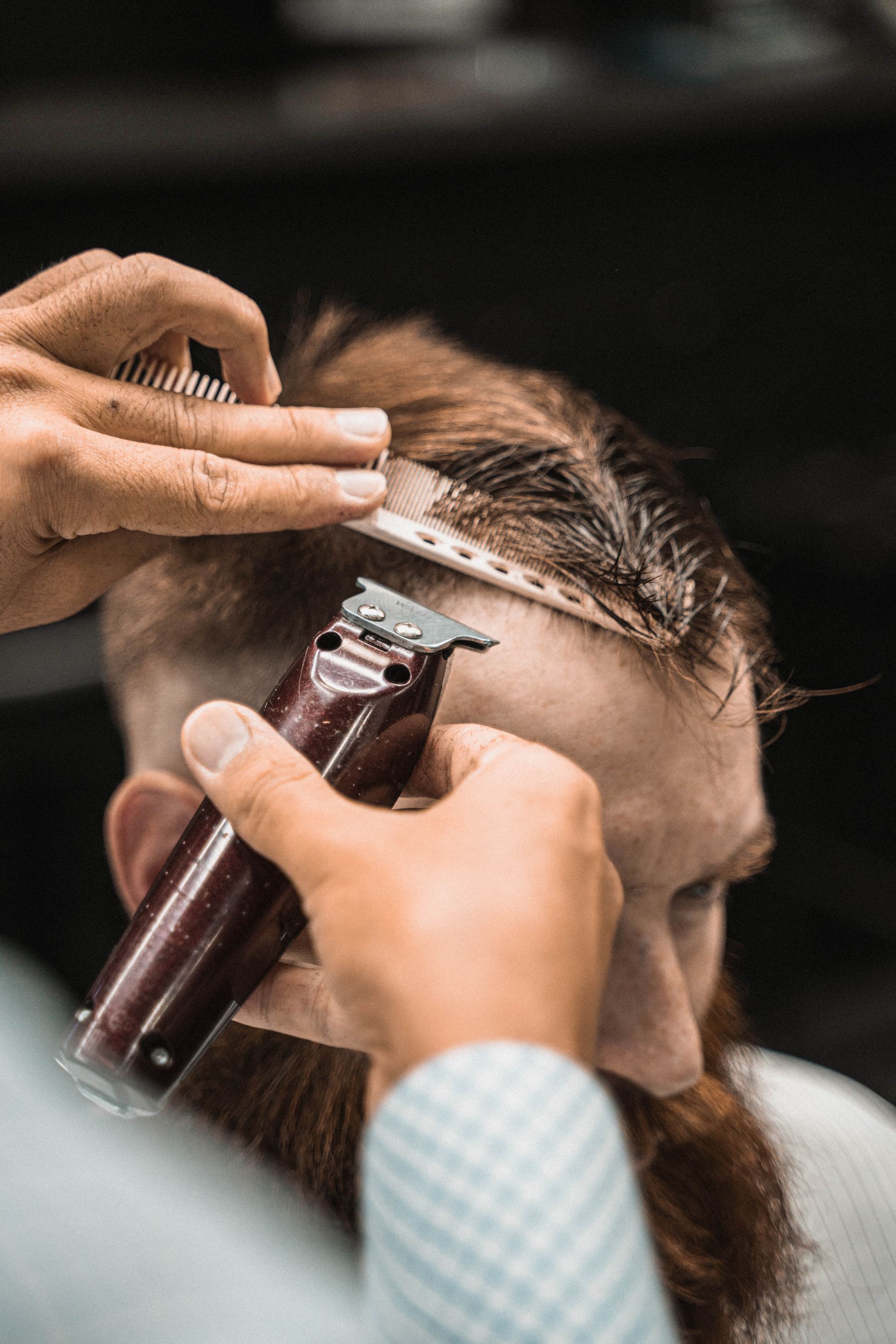 Close-up of clippers cutting hair